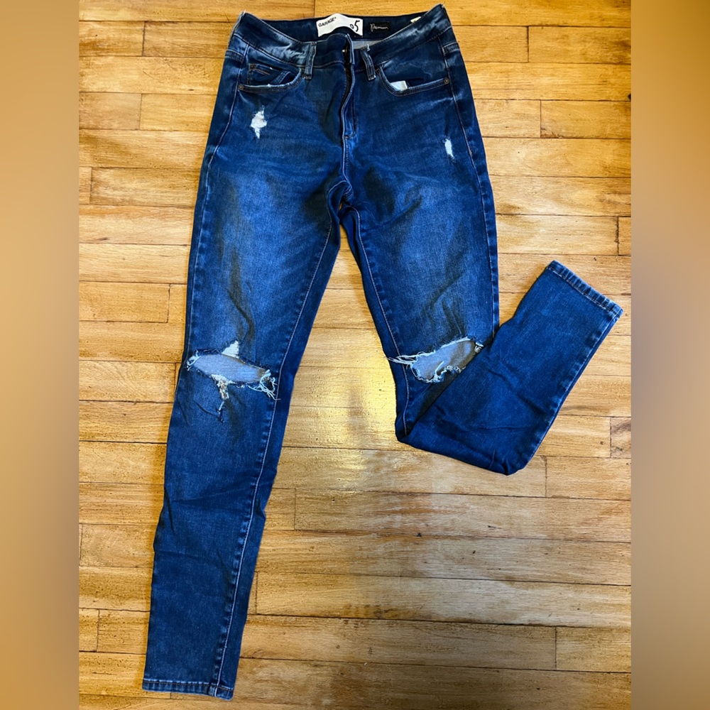 High-waisted jeggings. Dark blue, washed and ripped accents. Garage, size 5.